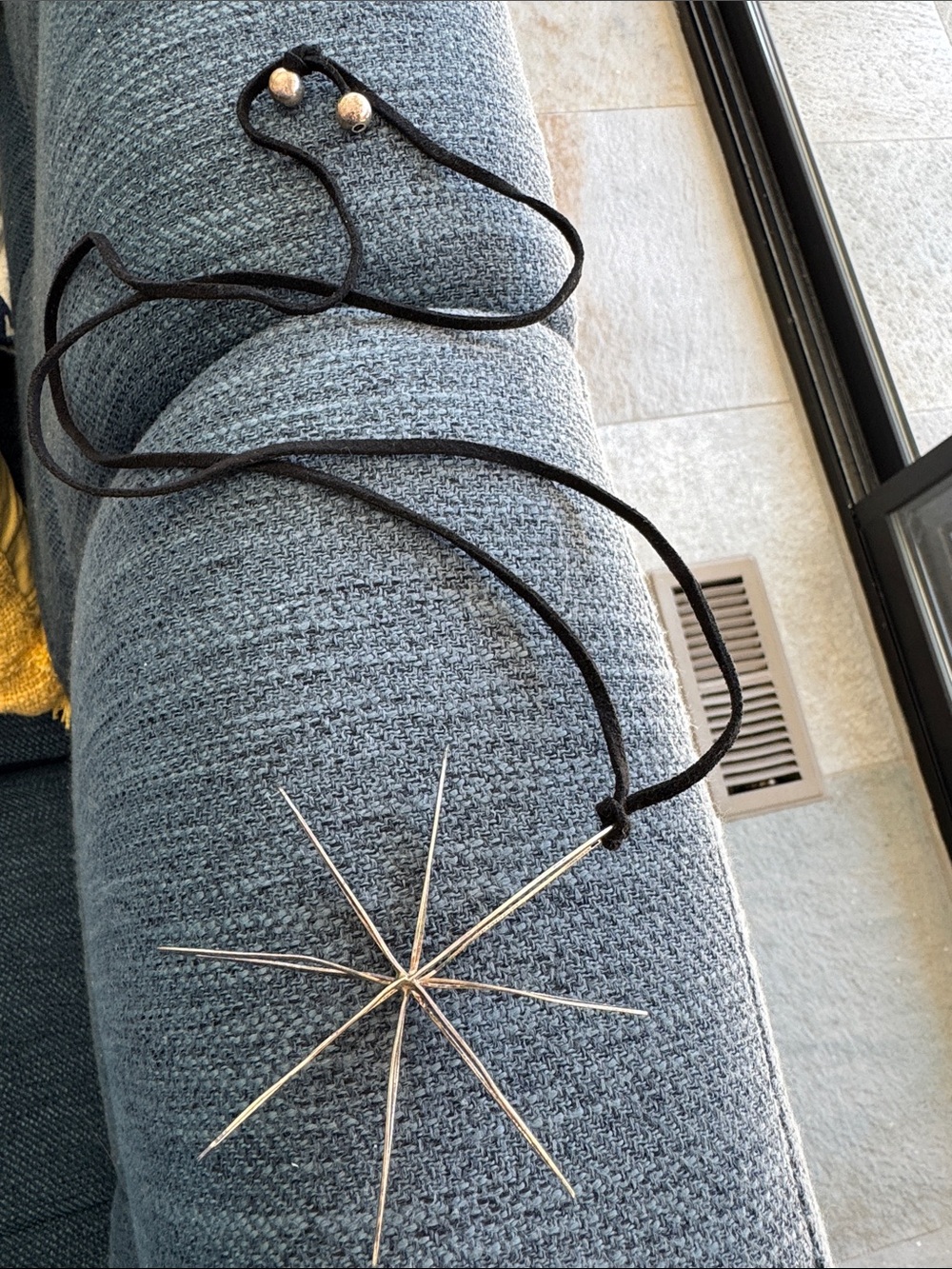 Silver Starburst Pendant Necklace with Black Cord